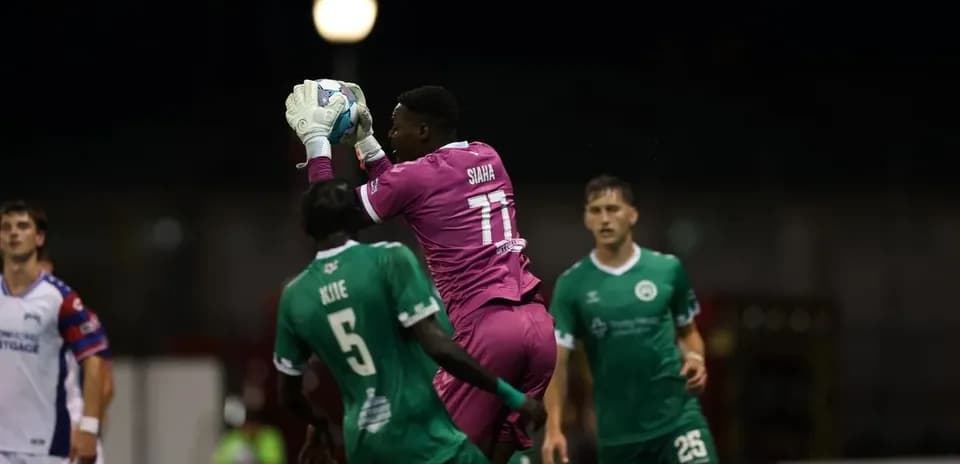Portero atrapa el balón durante el partido