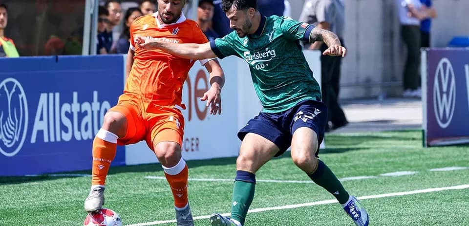 Dos jugadores compitiendo por el balón en el partido
