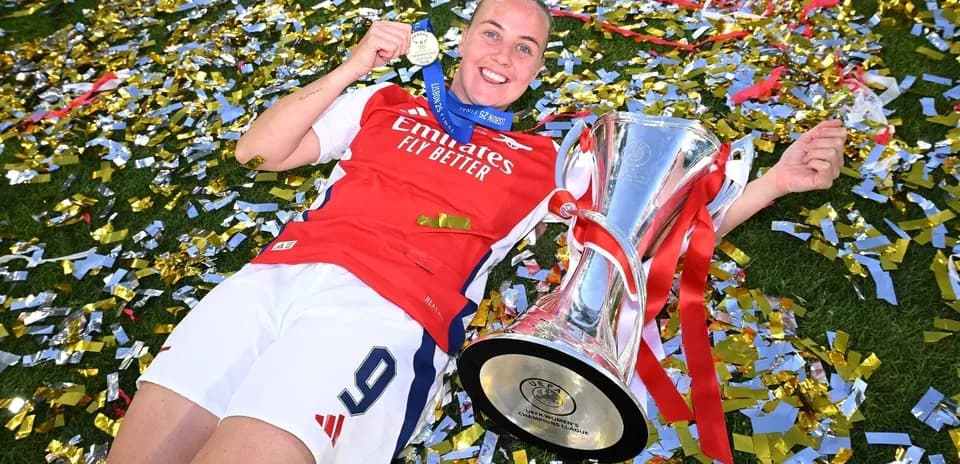 Jugadora con trofeo y medalla en el césped