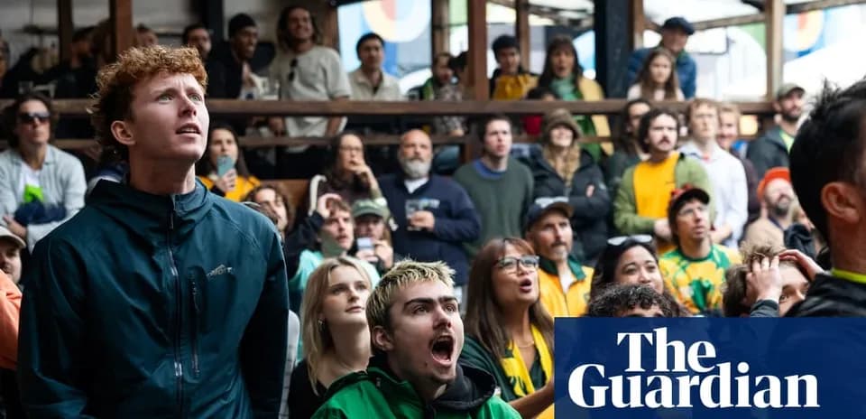 Agroup of fans watching a sports event in a venue
