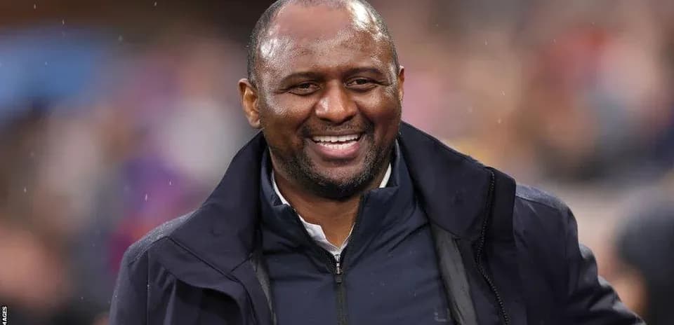 Entrenador sonriendo durante el partido
