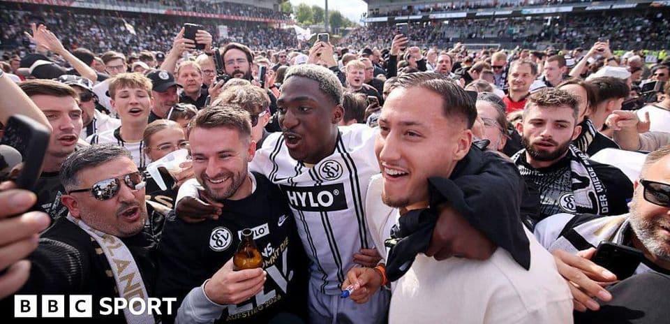 A group of fans celebrating with players after match