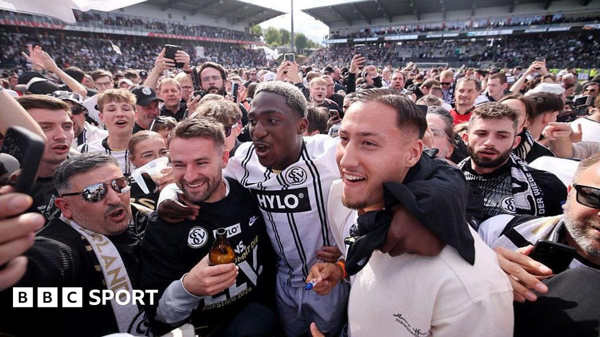 A group of fans celebrating with players after match