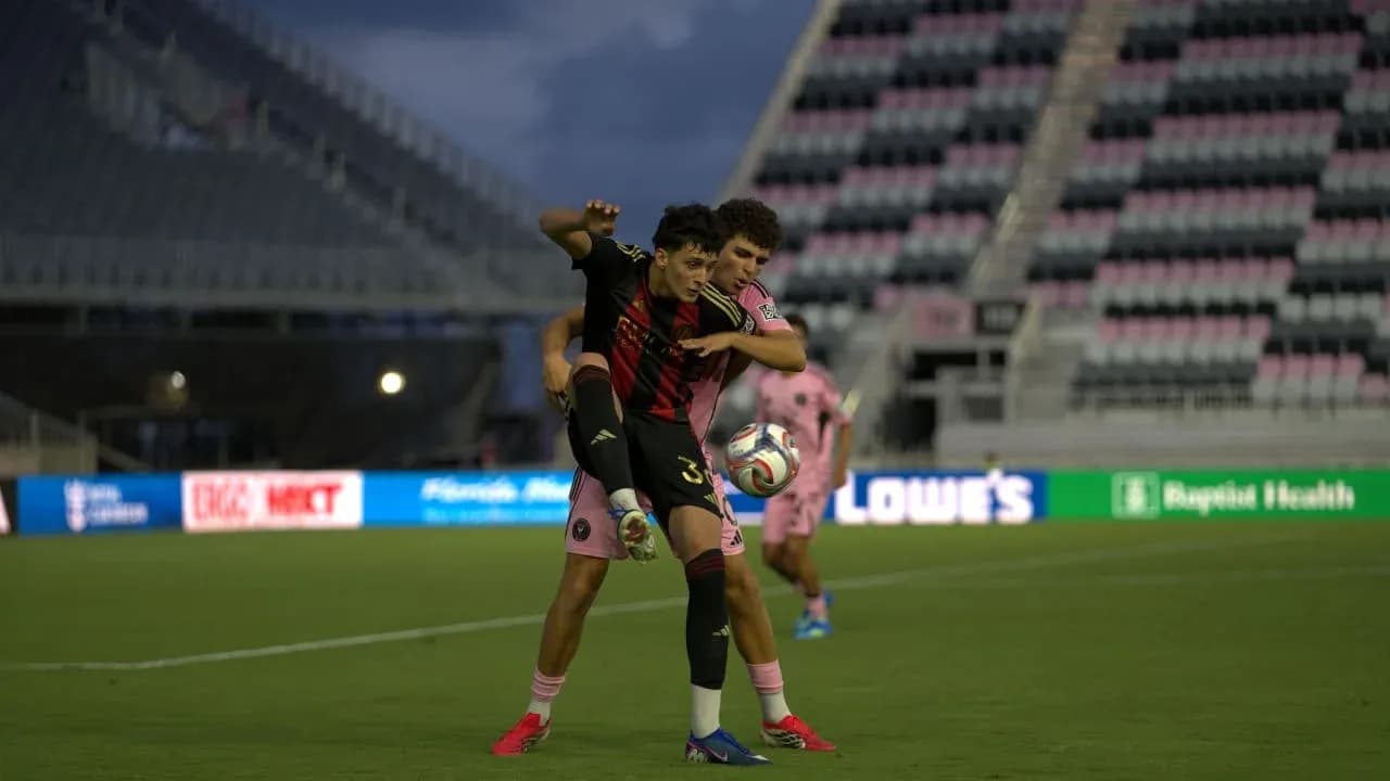 Dos jugadores luchando por el balón en el partido Dos jugadores luchando por el balón en el partido